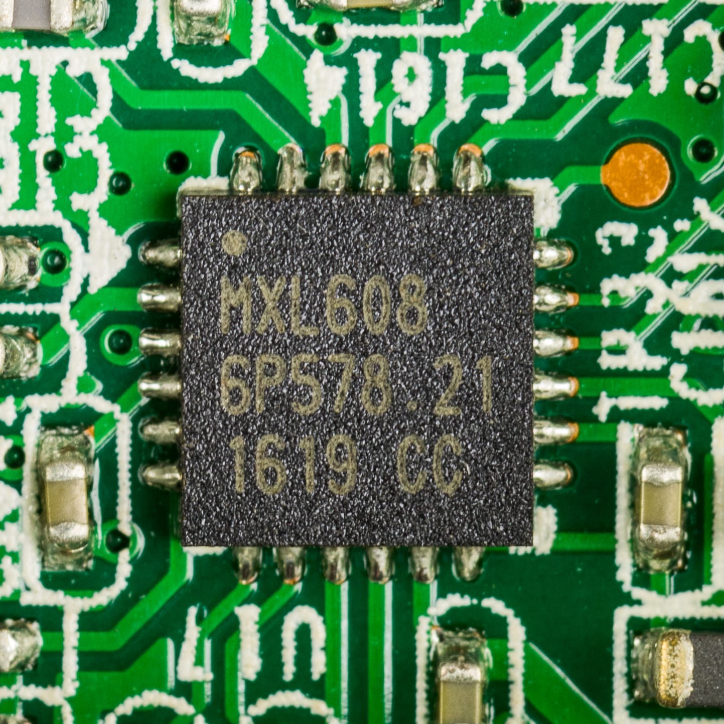 A MaxLinear MXL608 chip soldered on a green printed circuit board