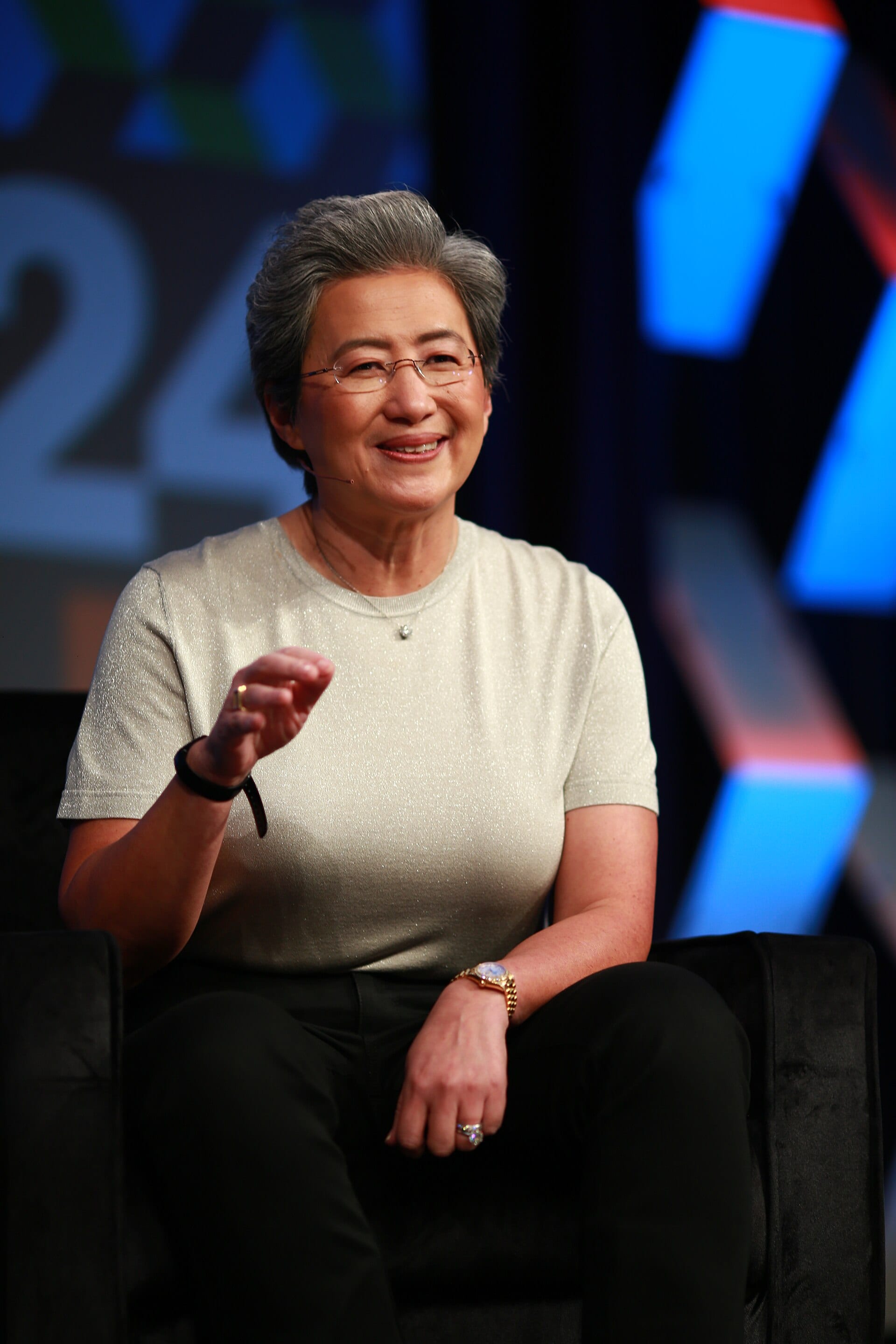 AMD chief executive Lisa Su seated onstage at SXSW 2024, gesturing as she speaks