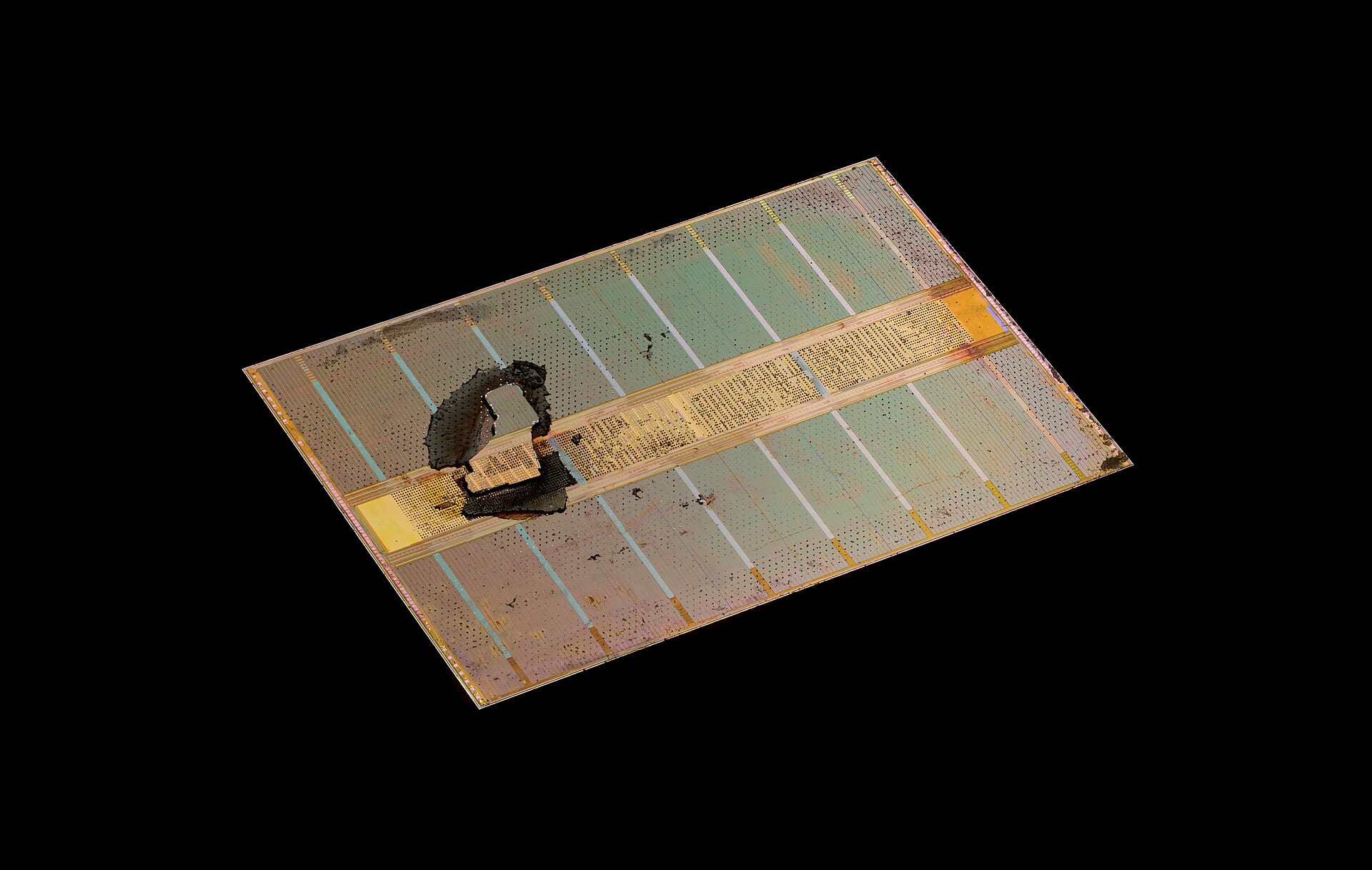 Die photograph of a high bandwidth memory stack, DRAM dies layered over a logic base die, on a black background