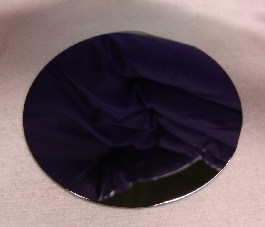 A two-inch gallium arsenide wafer with a mirror-polished surface