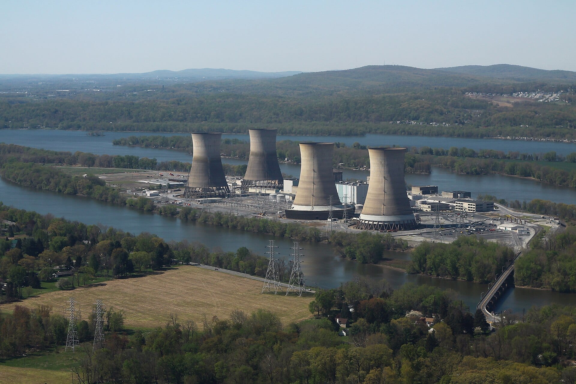Aerial view of Three Mile Island Generating Station, four cooling towers beside the Susquehanna River in Pennsylvania
