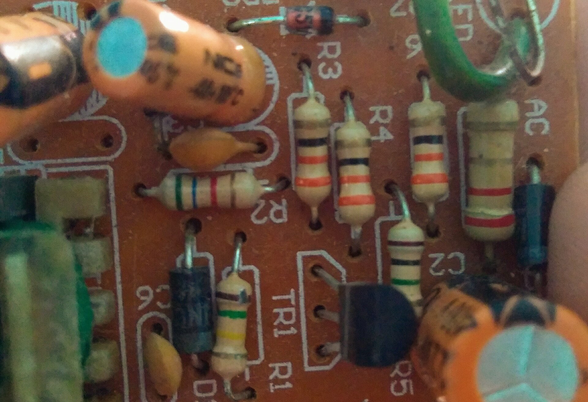 Resistors, diodes, capacitors and a transistor on a printed circuit board