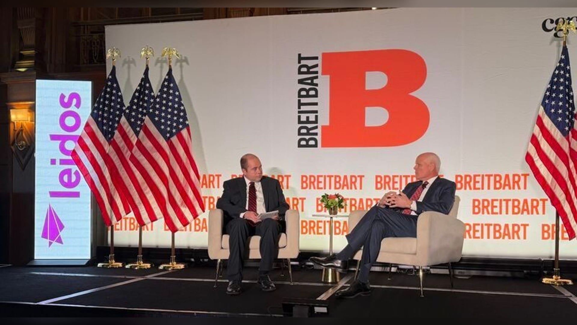 Leidos Chief Executive Tom Bell, left, on stage with Homeland Security Secretary Markwayne Mullin at a homeland security policy event