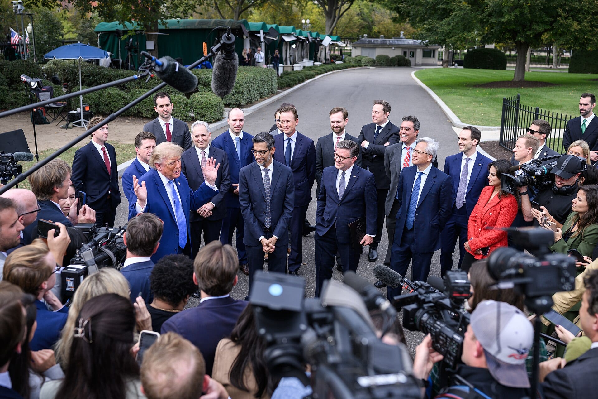 Sundar Pichai stands at the center of a group of tech chief executives with President Trump outside the West Wing