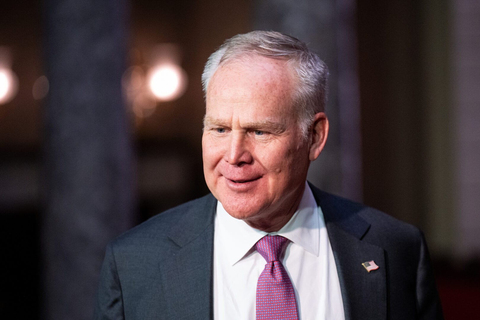 Senator Alan Armstrong, in a dark suit and red patterned tie, at his ceremonial swearing-in in the U.S. Capitol in March 2026