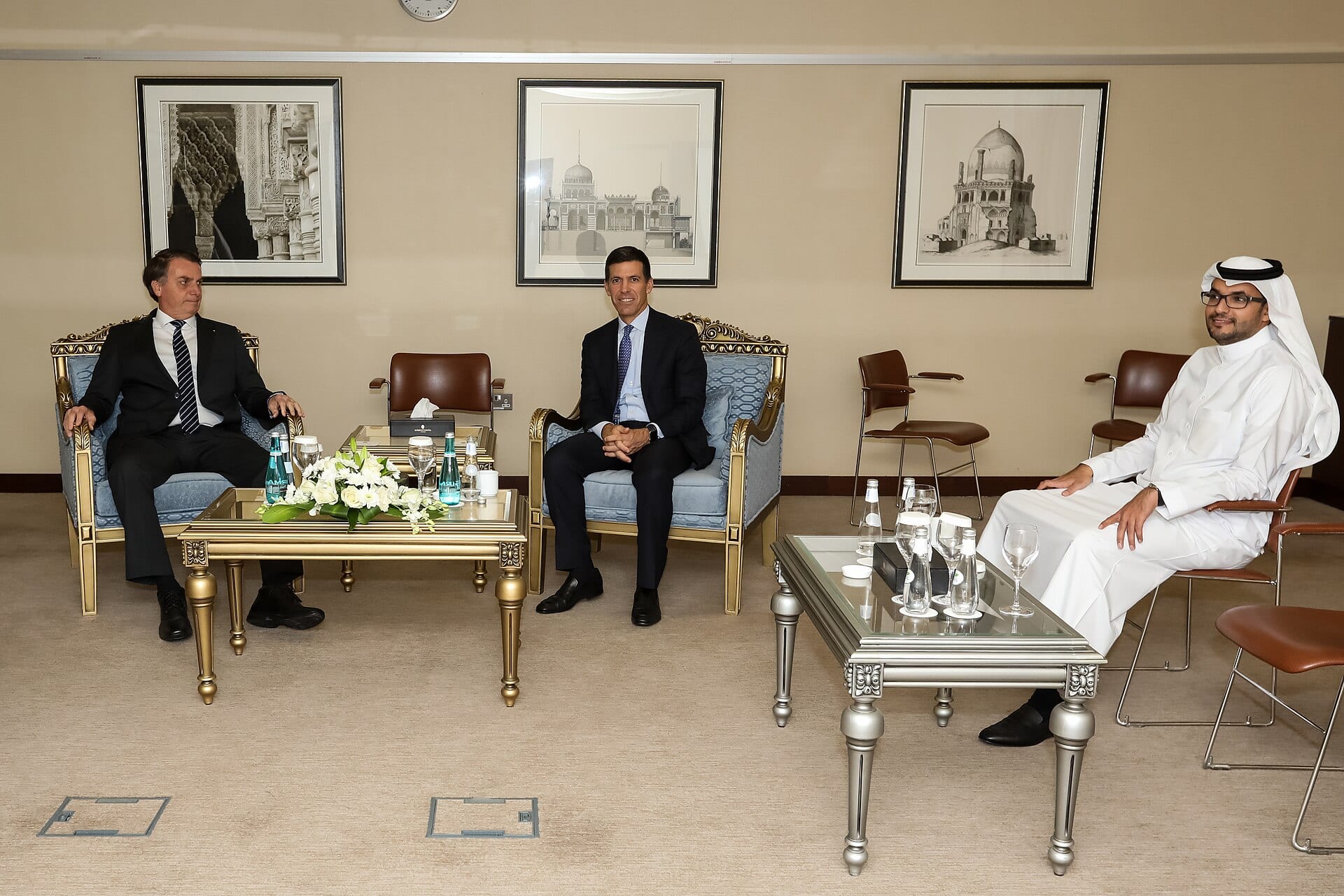 John Waldron, president of Goldman Sachs, seated between Brazil's President Jair Bolsonaro and a Saudi official during a meeting in Riyadh