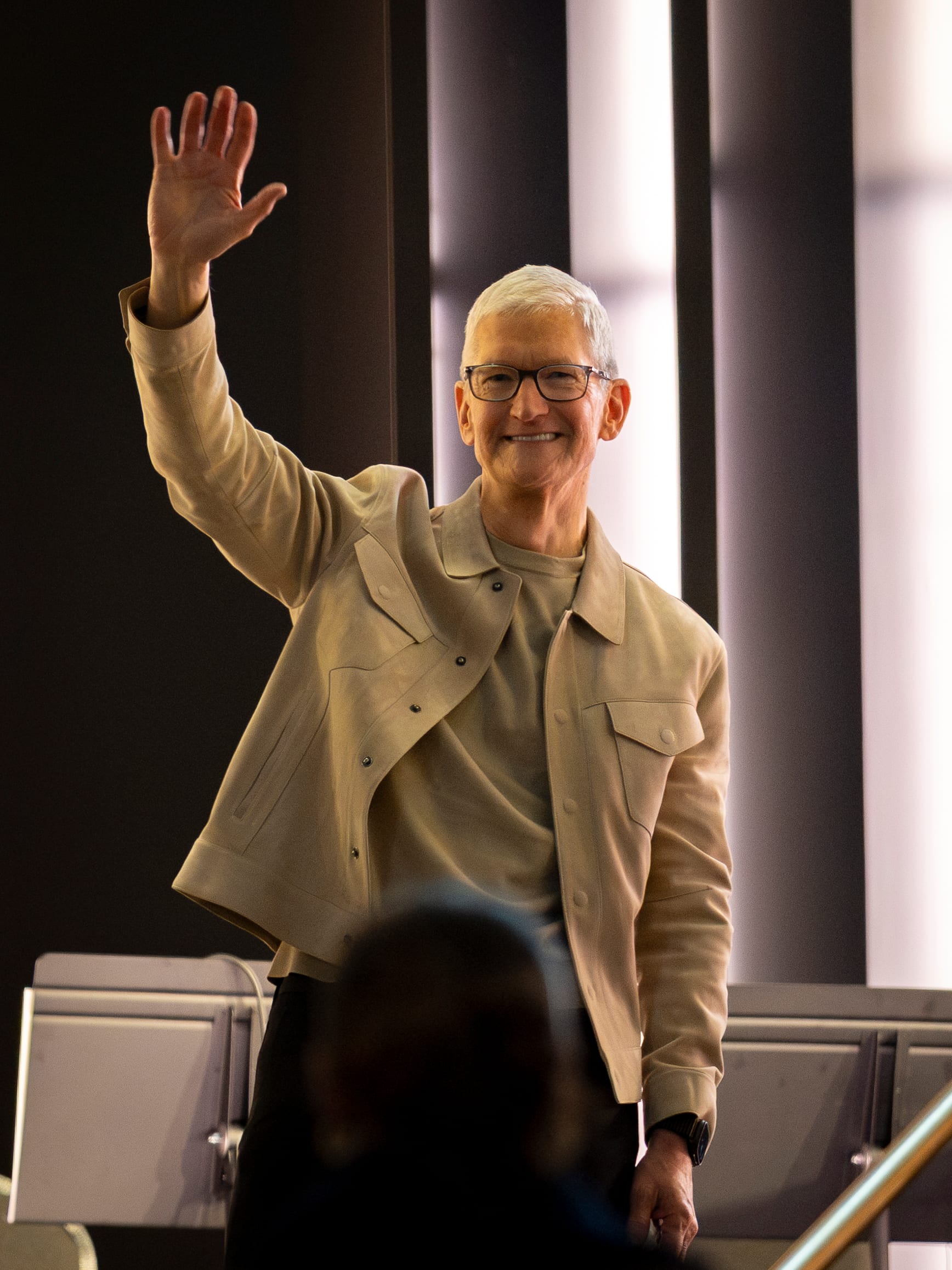 Tim Cook waves to attendees during Apple's 50th-anniversary kickoff event in New York City, March 13, 2026