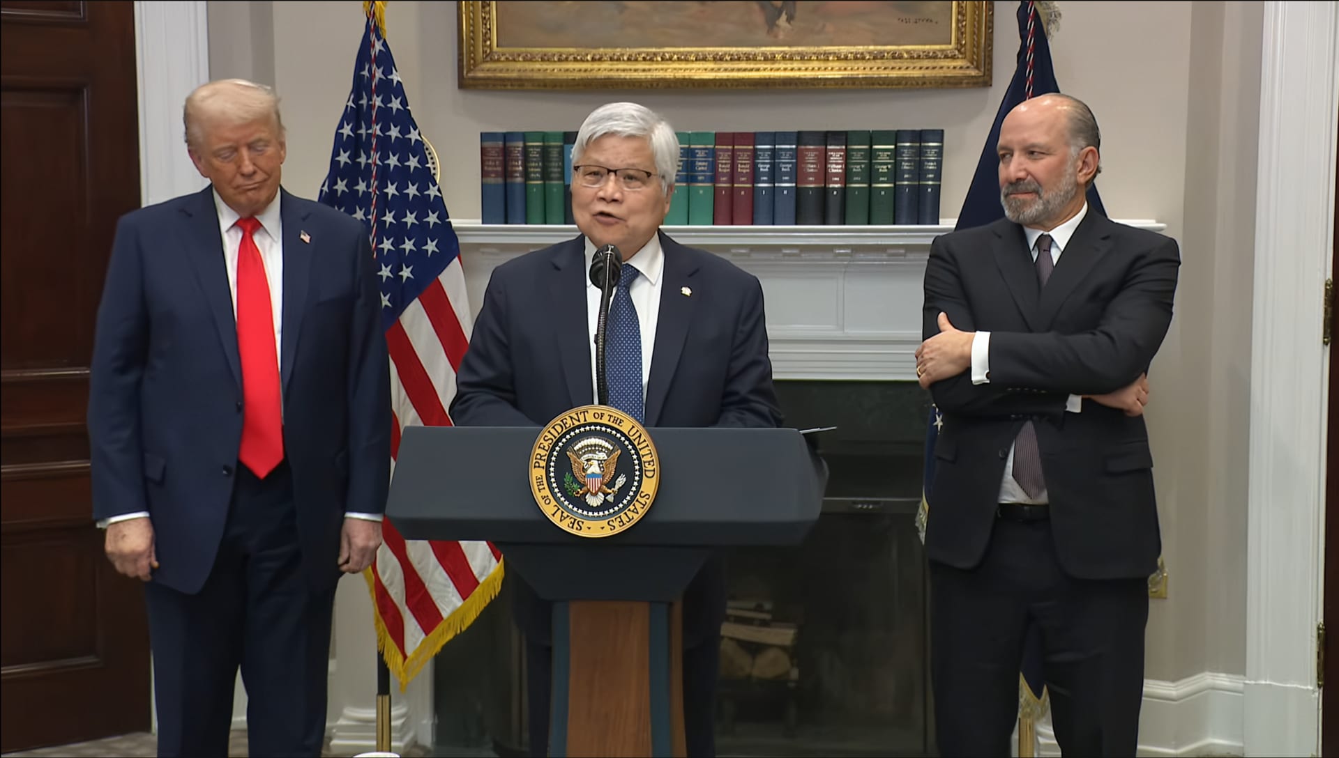 TSMC chief executive C.C. Wei speaking at a White House podium, with President Donald Trump at left.