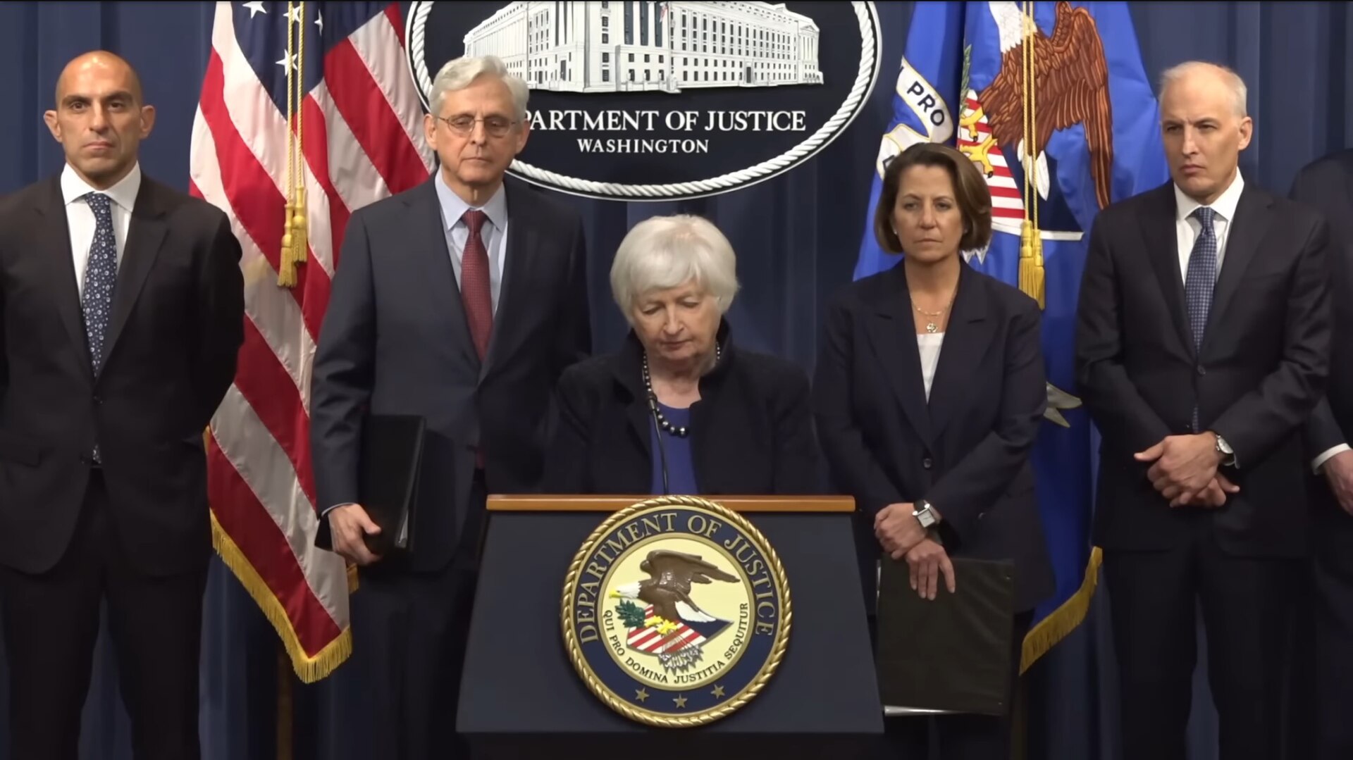 Justice Department officials at the podium announcing the Binance guilty pleas in 2023