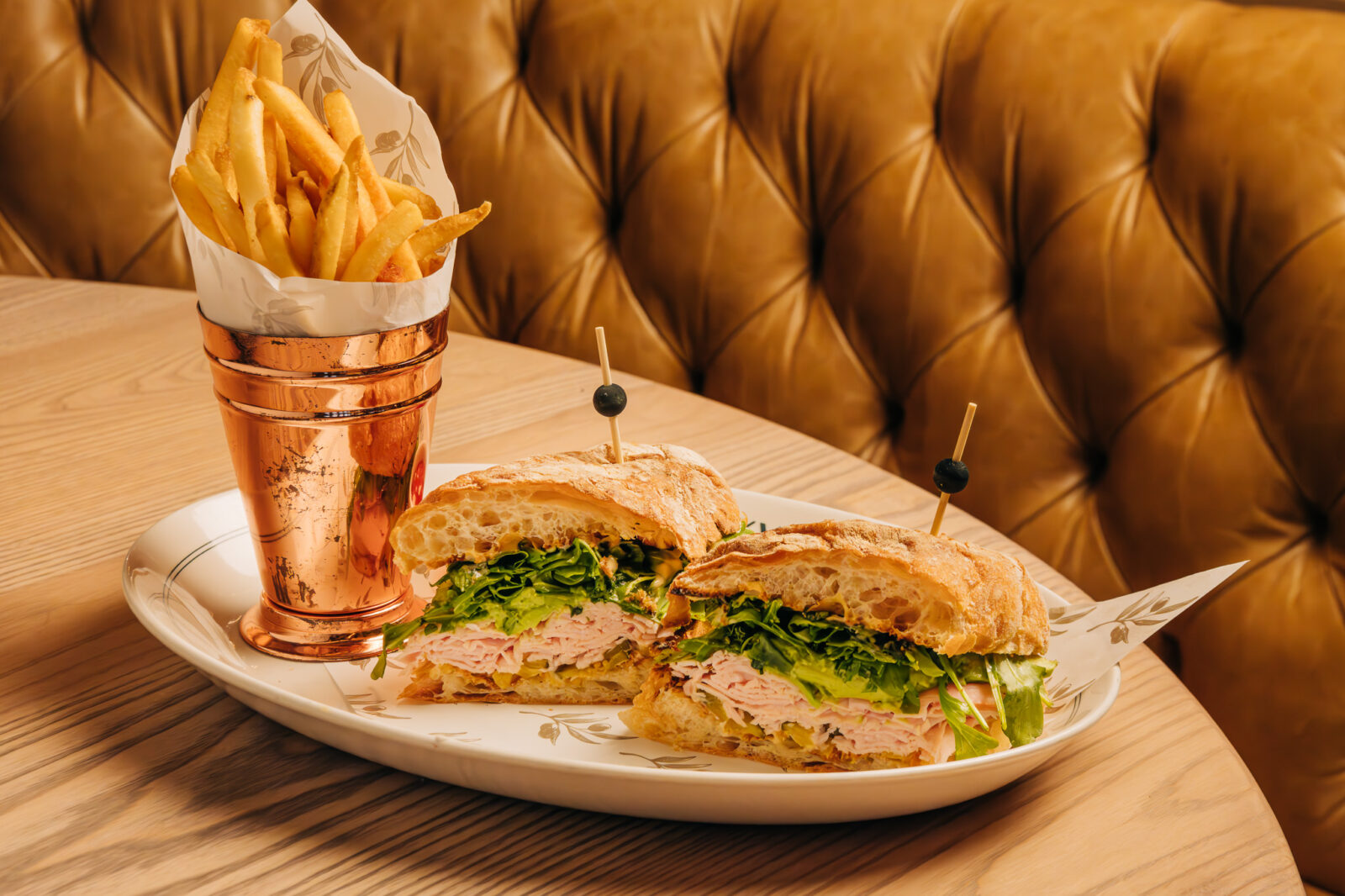 The Oakville's Hobbs Turkey and Avocado Sandwich served with fries available for carryout and delivery