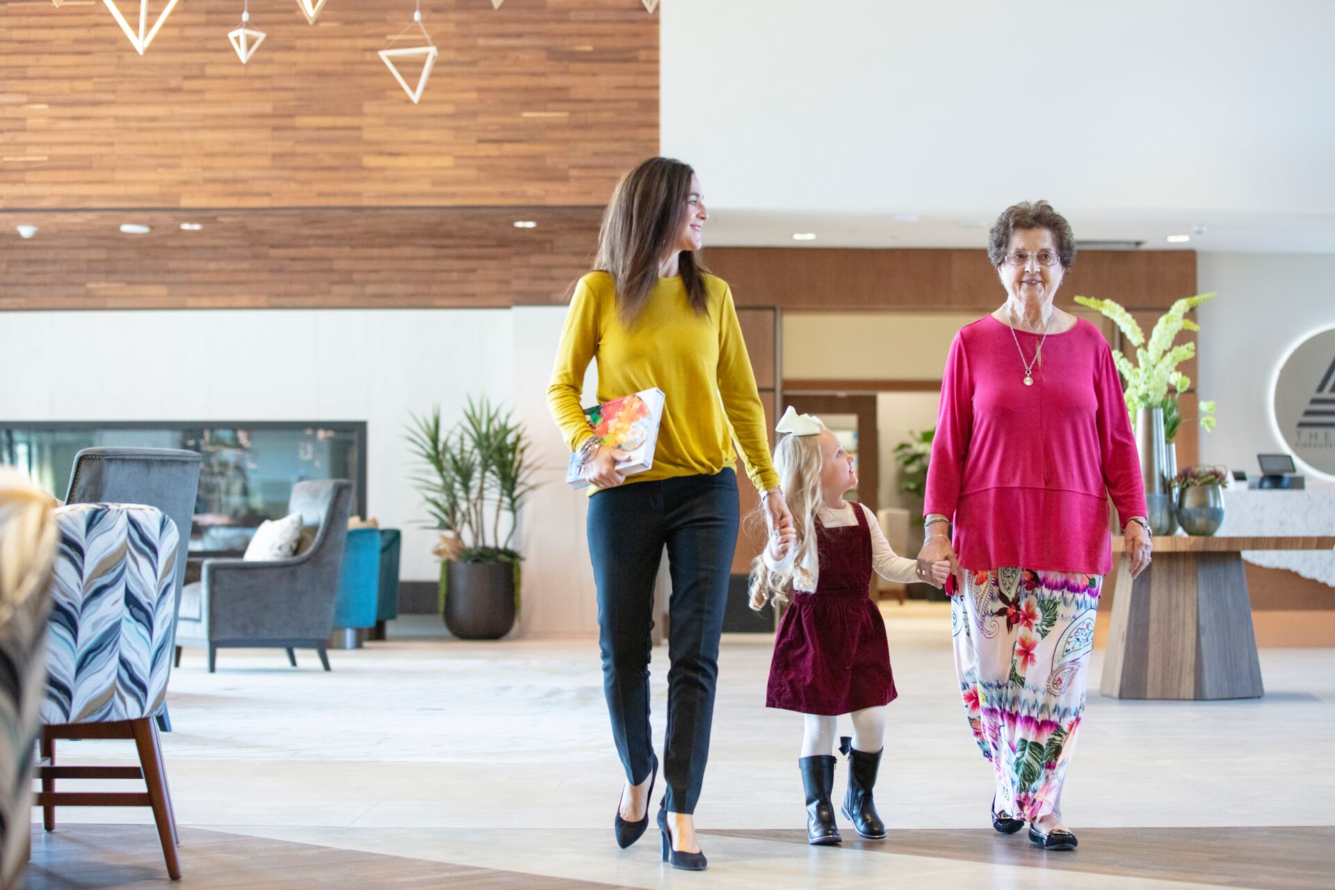 A grandmother, daughter, and granddaughter walk together