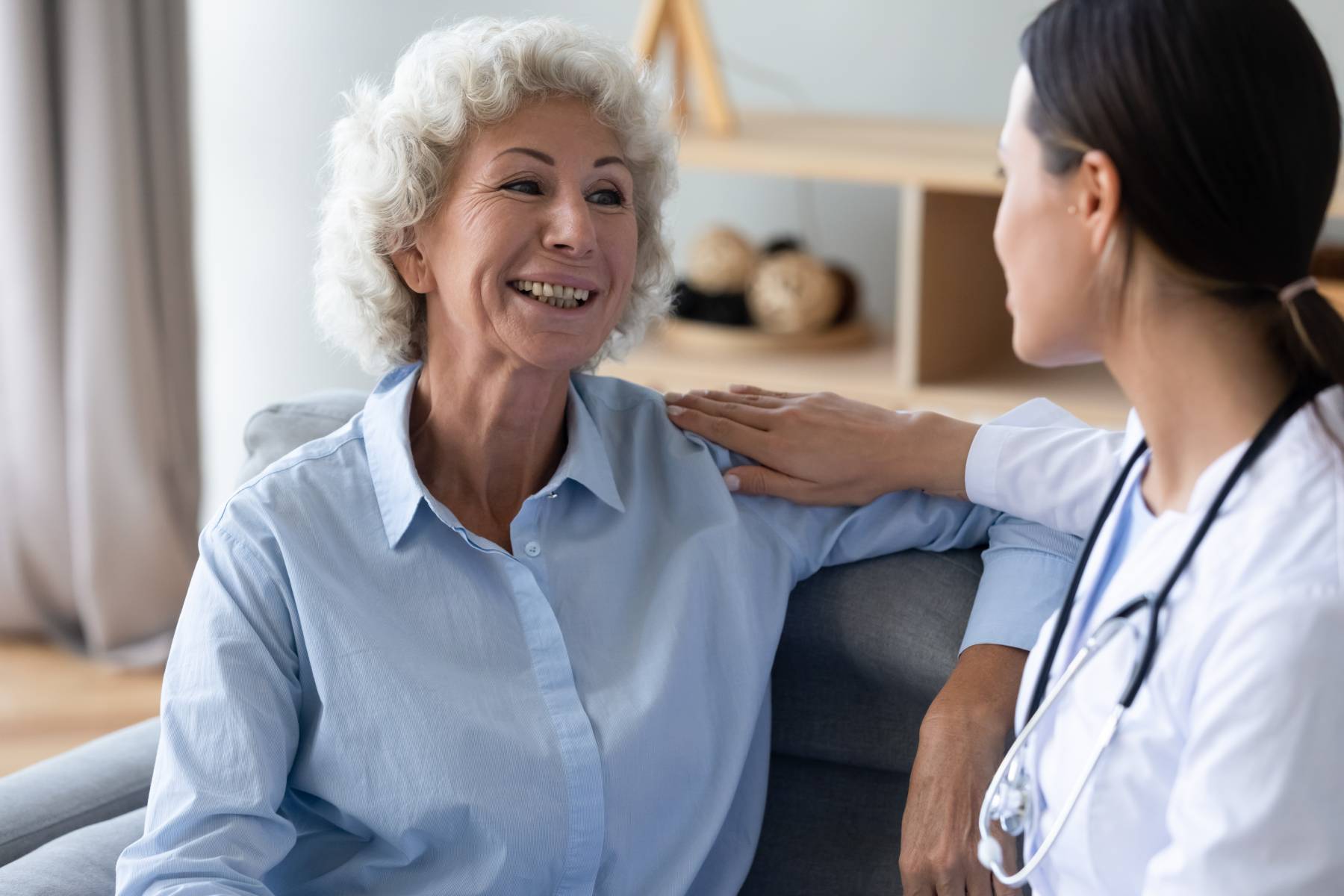 senior lady in assisted living talking to a nurse