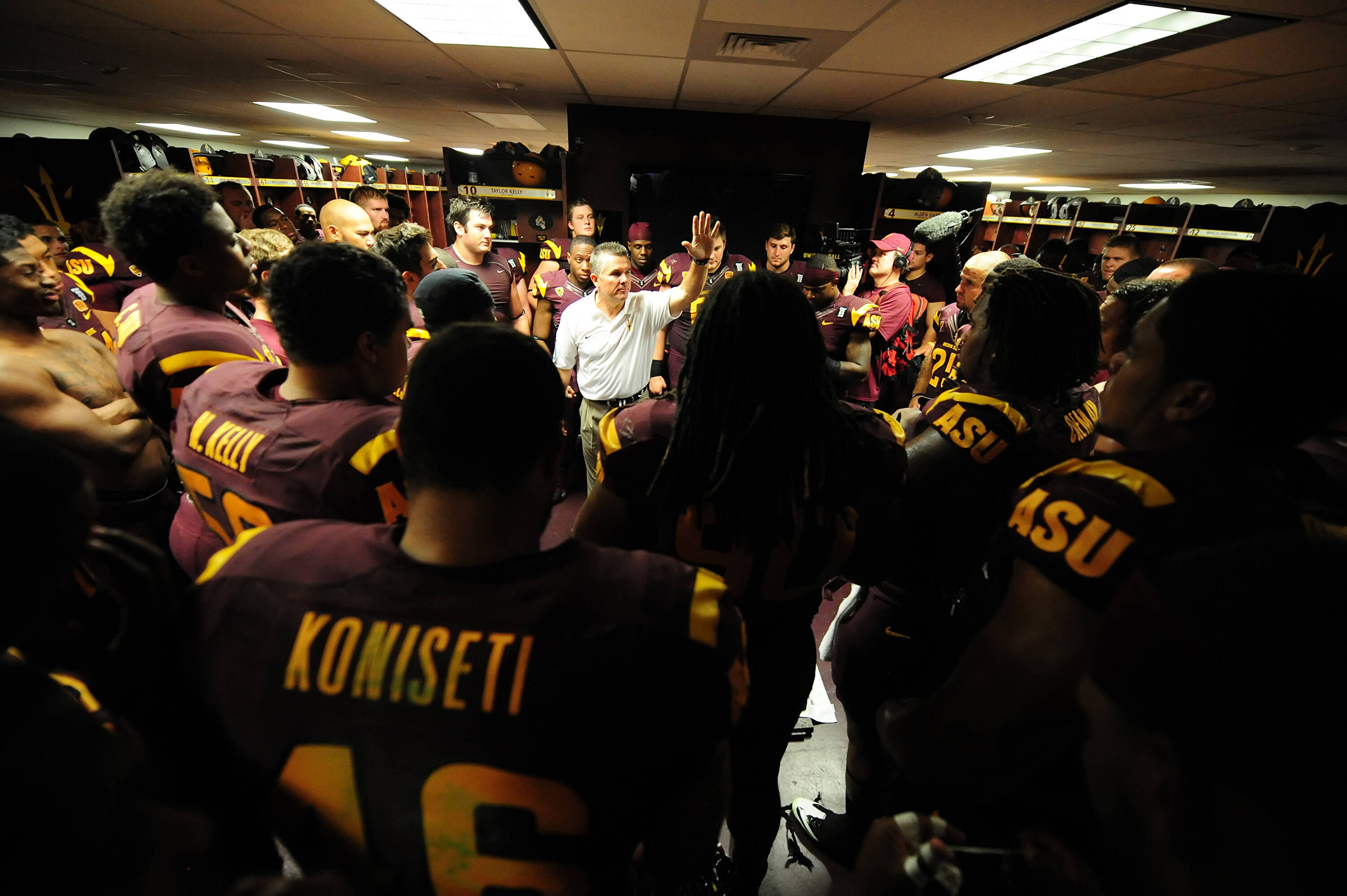 Coach Graham talks to the team in the locker room 