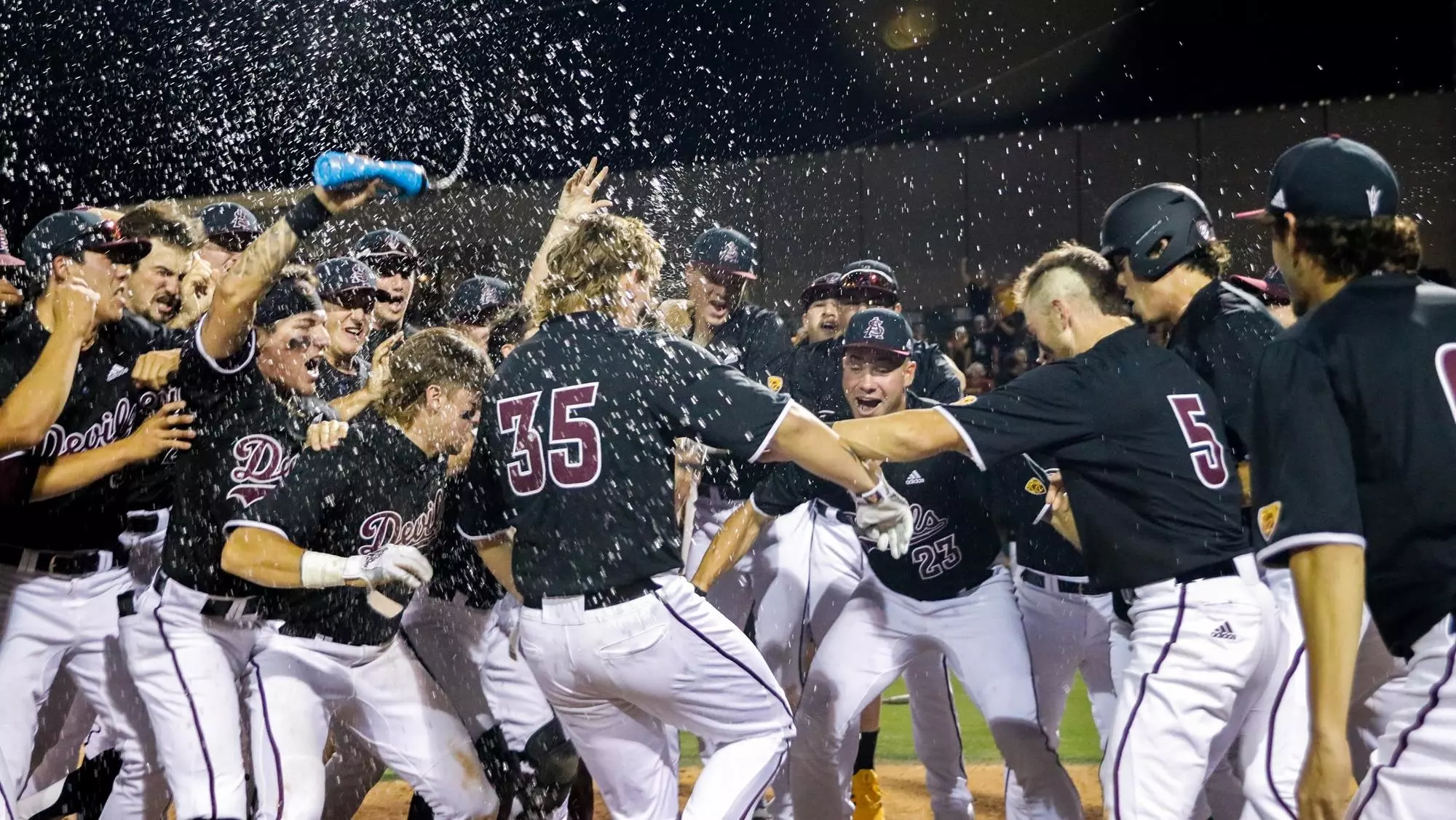 Long was mobbed by his teammates after his three-run walk-off homer sealed a 9-6 Sun Devil win over Oregon State..webp
