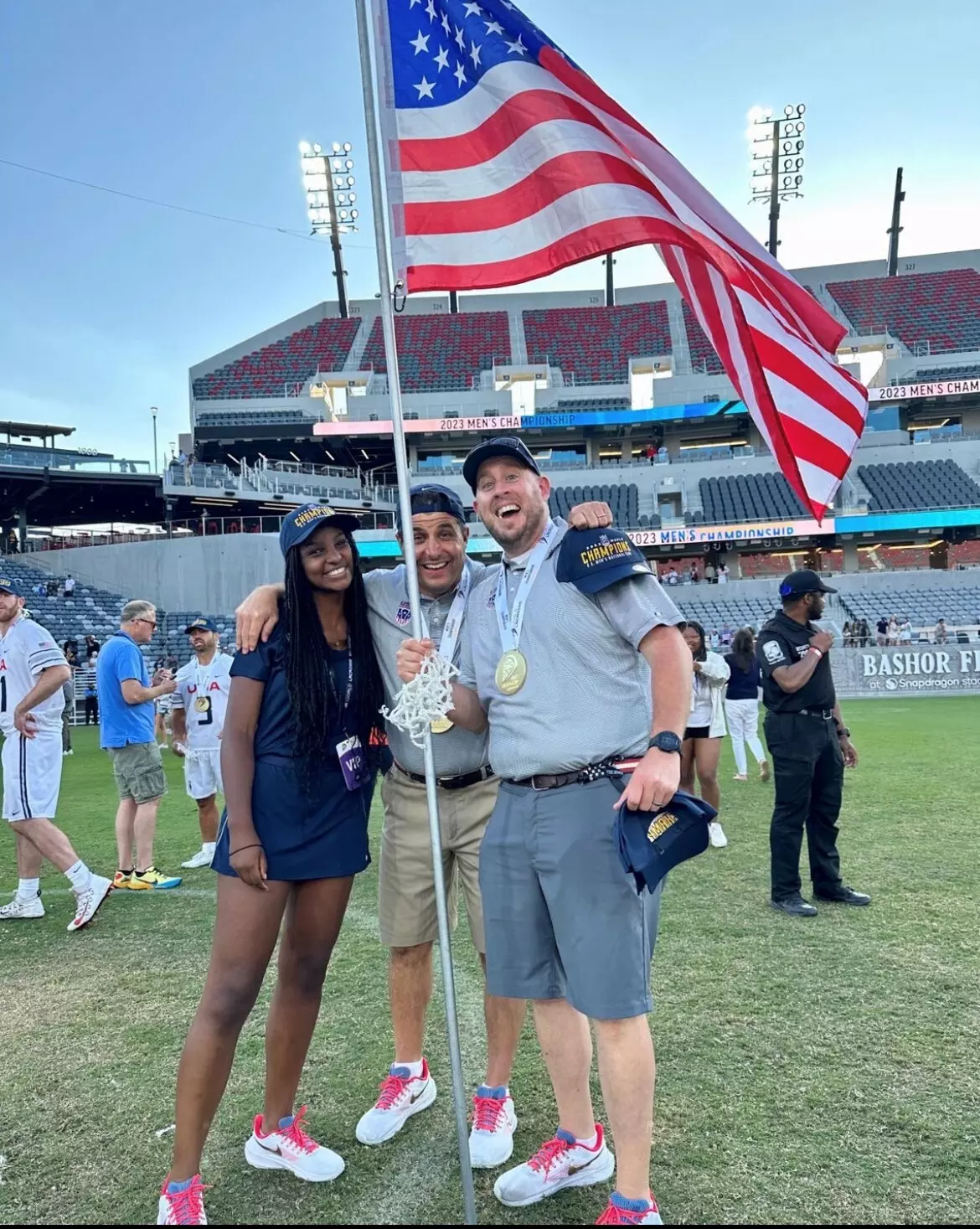 This was post the USA Men's Lacrosse Championship game. The man in the middle is Joe Amplo one of the assistant coaches for Team USA and the current Head Coach of Navy.webp