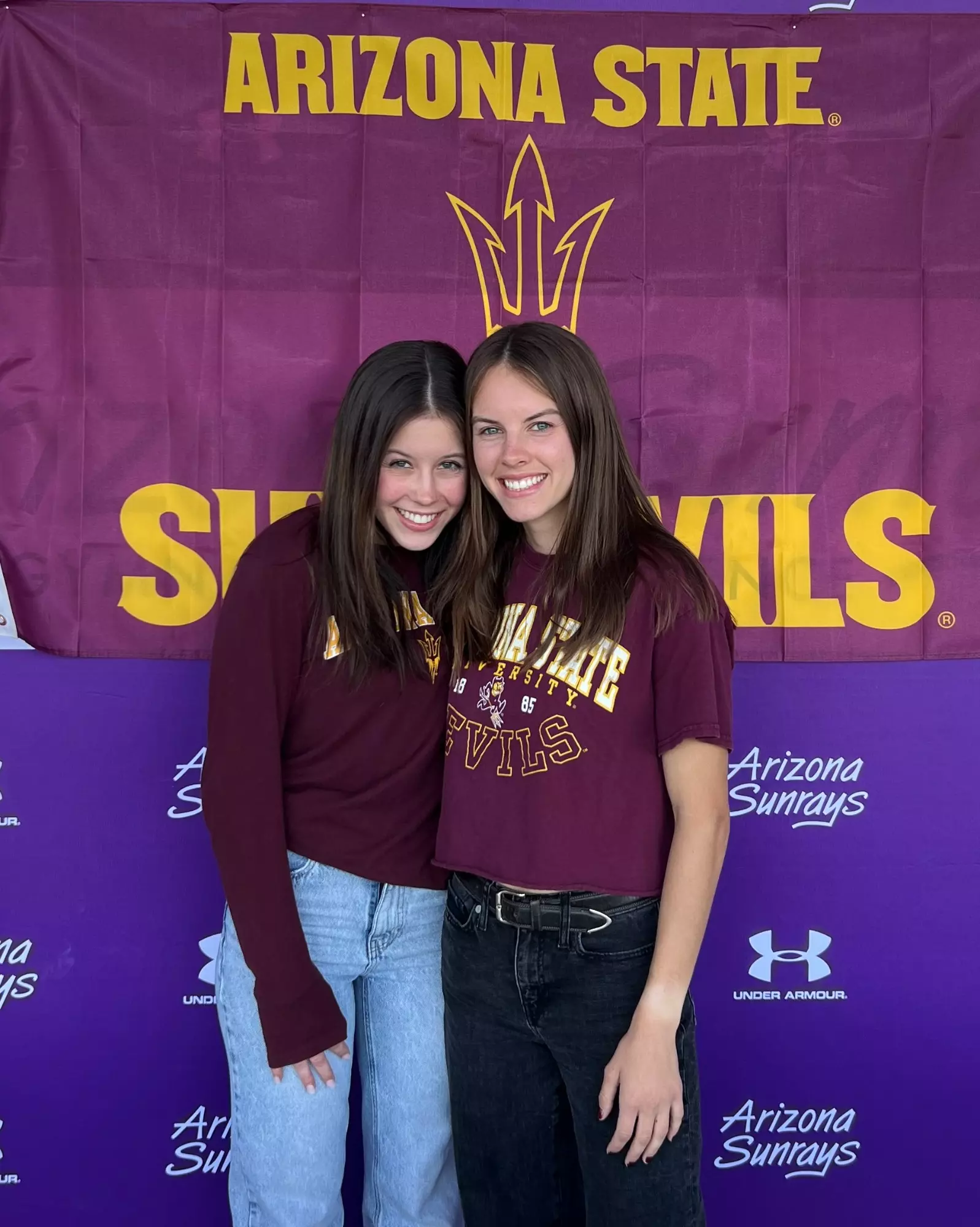 Lee-sisters-in-front-of-asu-banner.webp