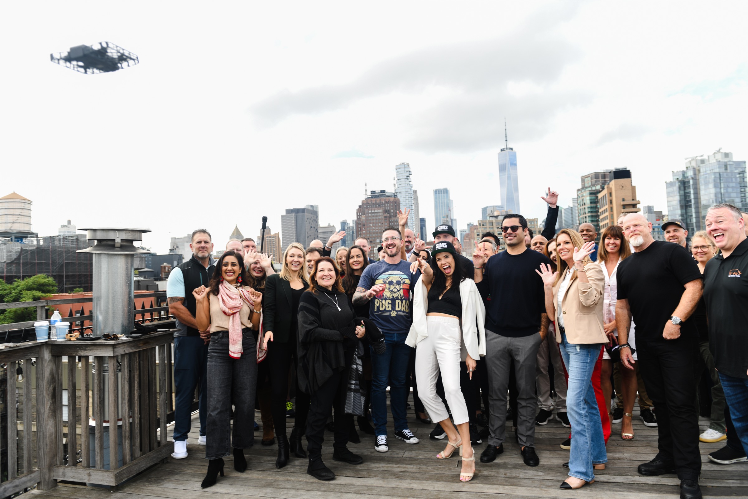 Brian Bogert with community group on NYC rooftop with drone and skyline