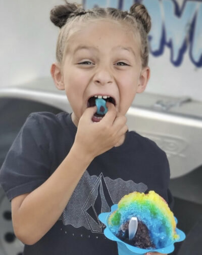 Young girl enjoying a Northern Brain Freeze Hawaiian shaved ice