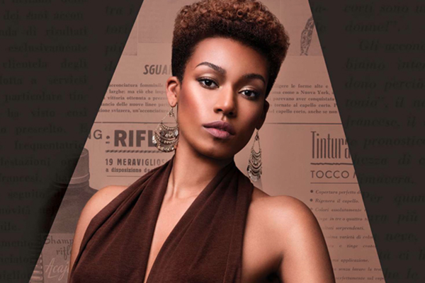 A woman wearing a brown halter top, she looks at the camera