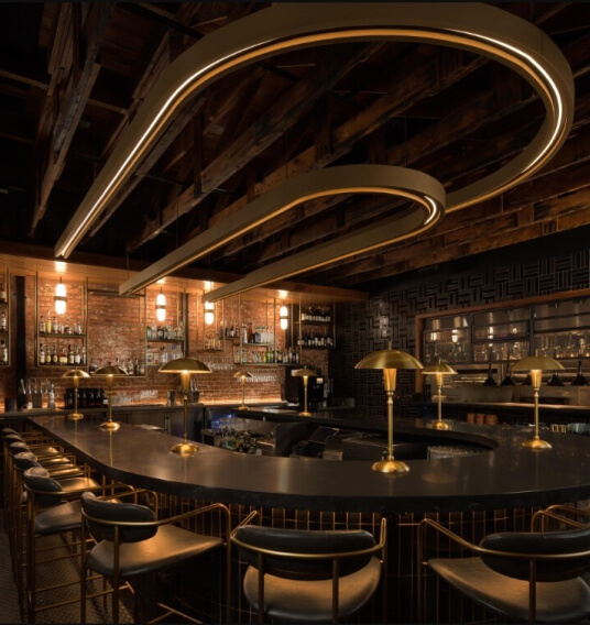 Cover Image for Interior bar shot of Rare Society. The bar has black and gold accents