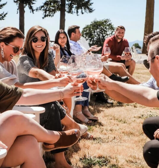 MacRostie - People cheersing with wine glasses outside