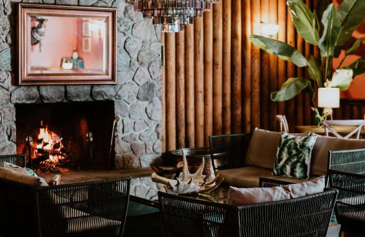 Intimate restaurant setting adorned with a fireplace and chandelier