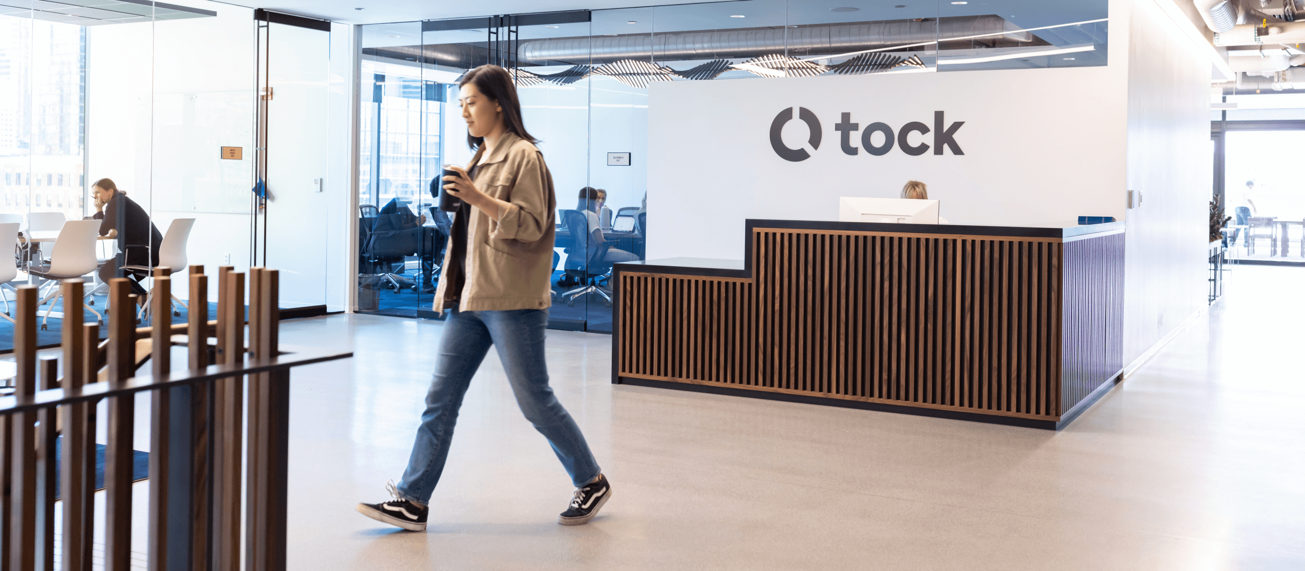 Tock office space with employees walking and taking meetings