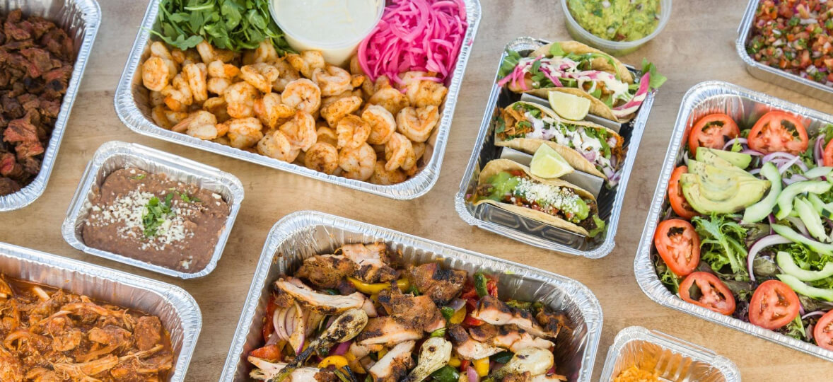A spread of take-out containers from a Mexican restaurant.