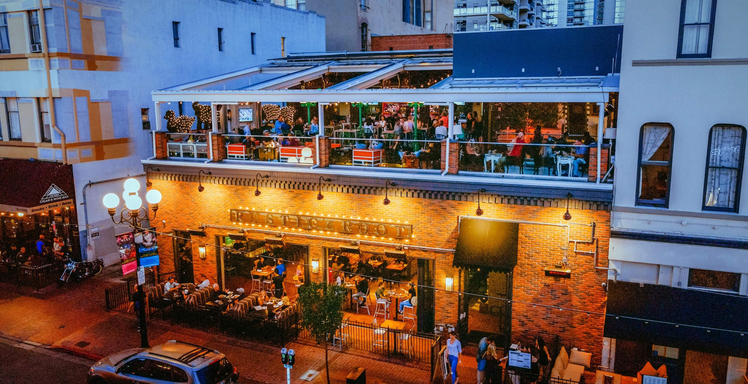 An image of a busy restaurant with windows into their dining room and an exposed rooftop.