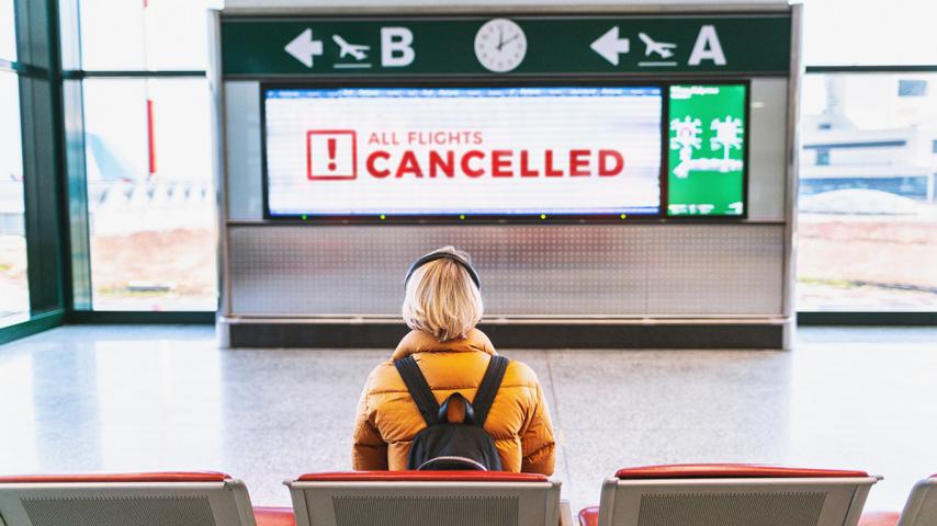 Woman looking at a flight's cancellation dashboard