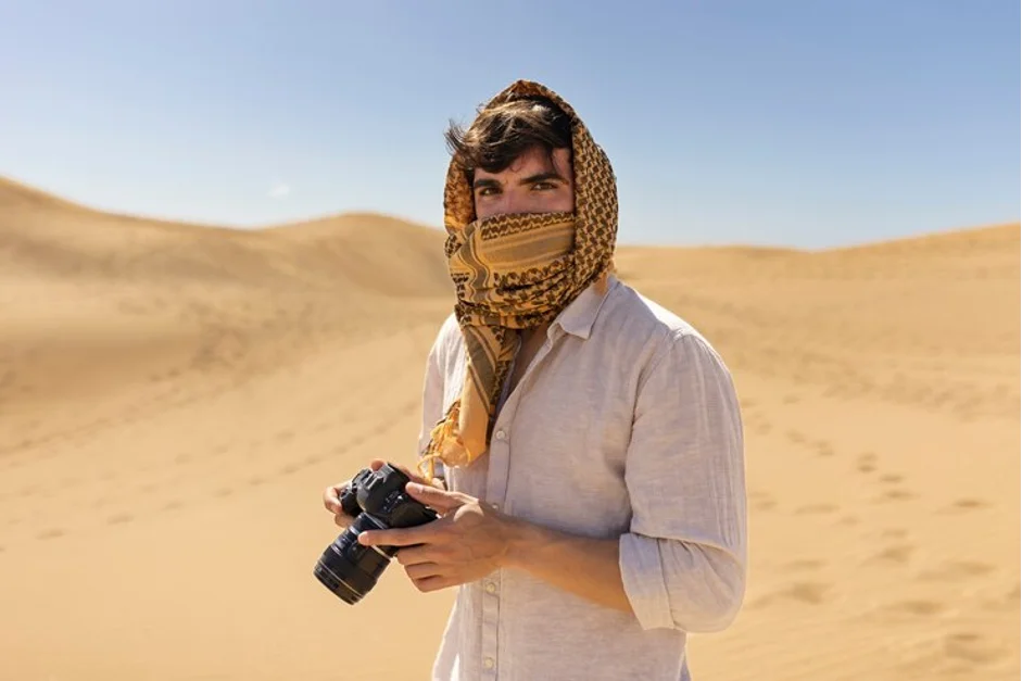 A traveler taking photos in Dubai's Desert