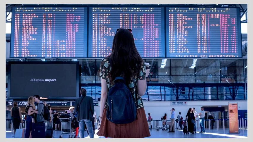 Traveler looking at currency exchange rates