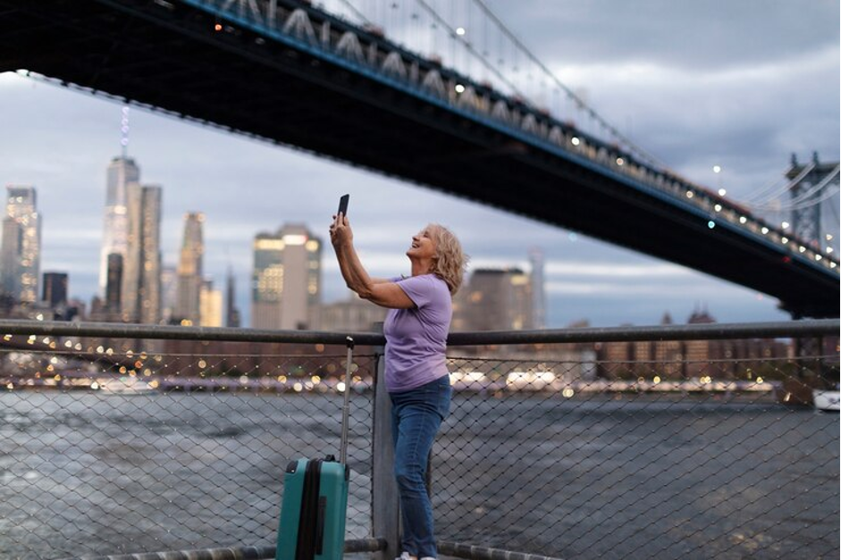 woman taking a selfie under a bridge