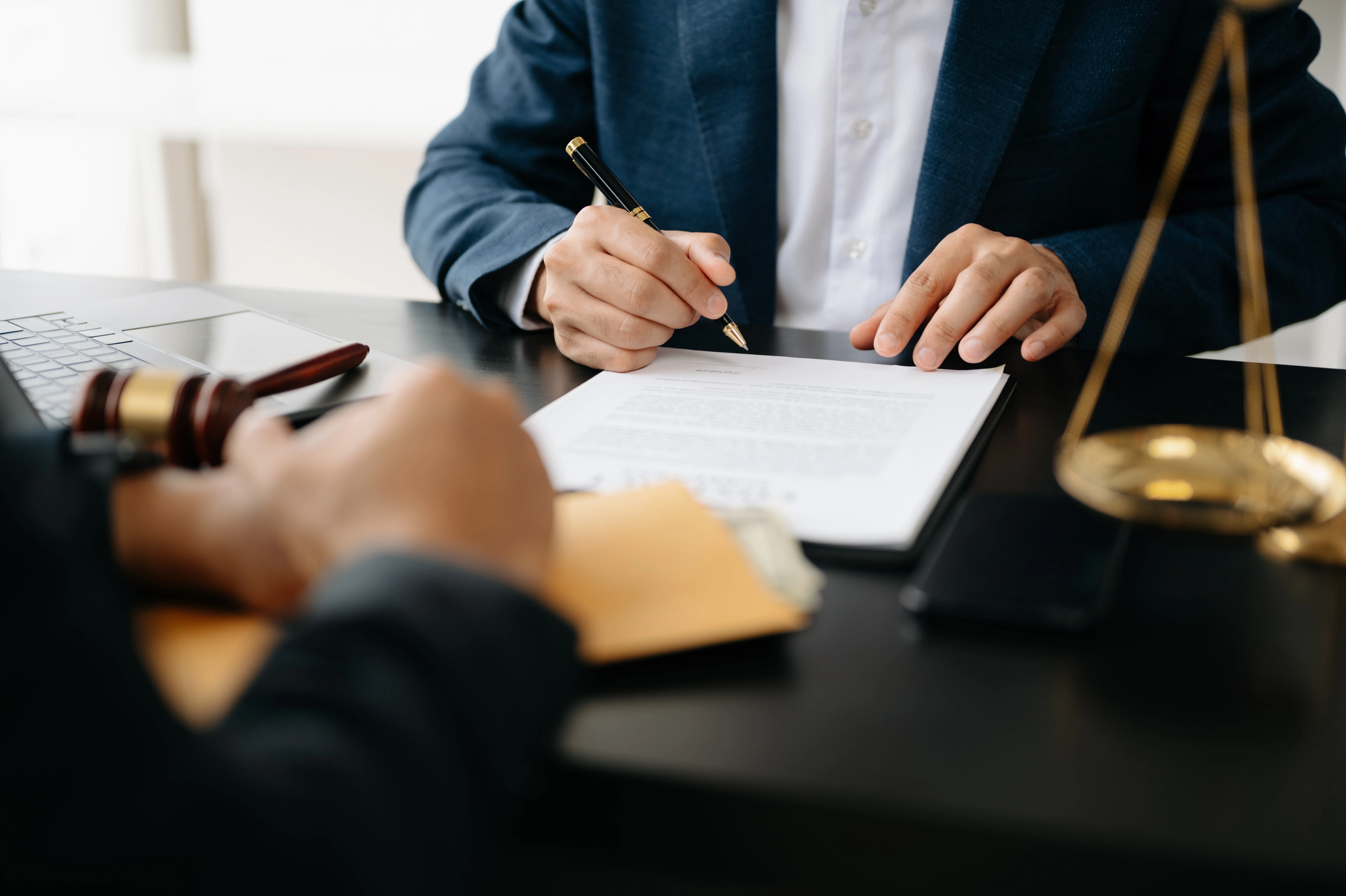 Picture of a man signing a legal contract