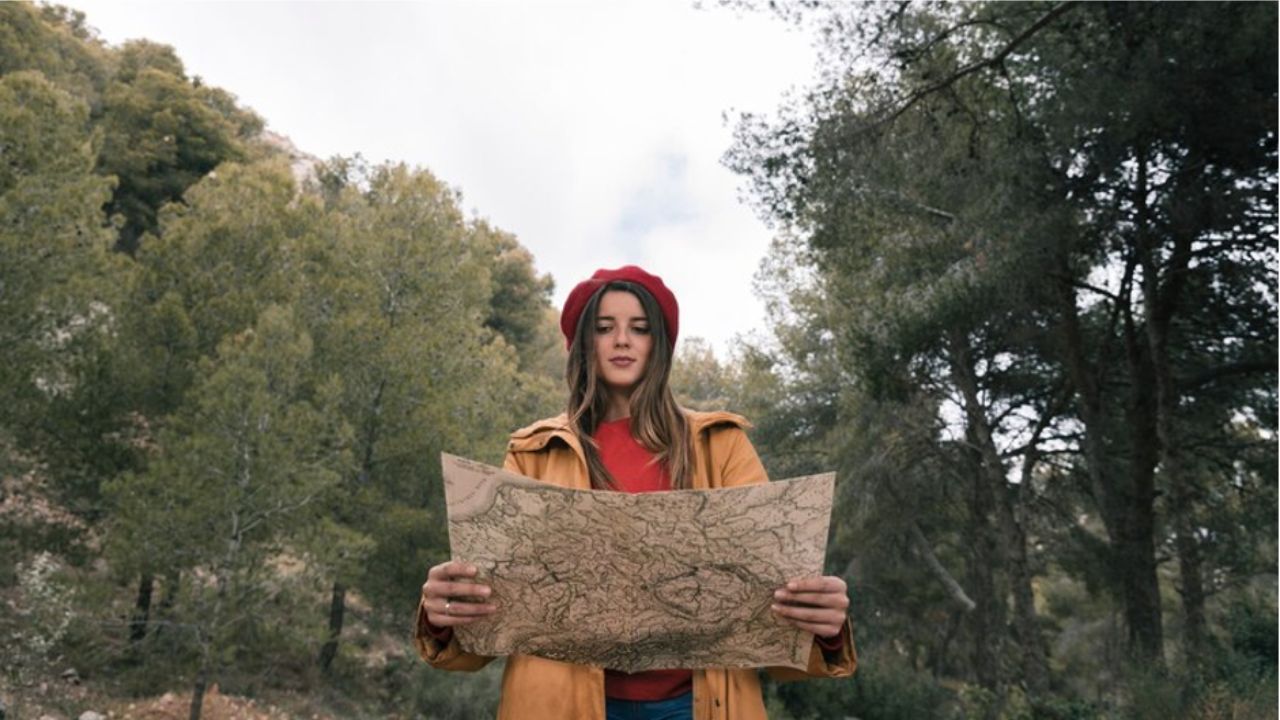 Woman reading a paper map Woman reading a paper map