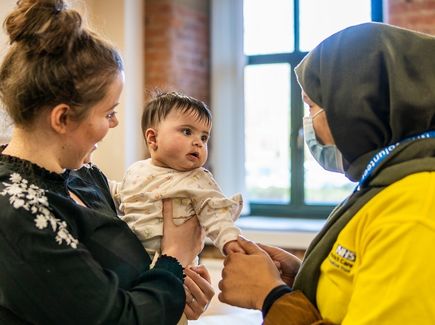 Volunteers with baby Compressed