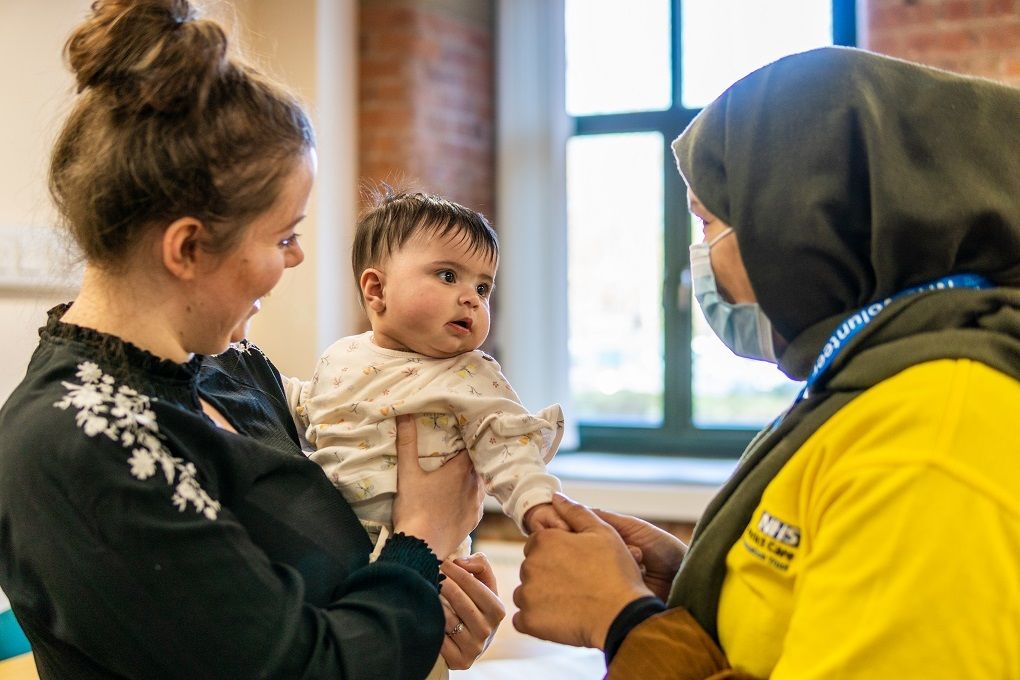 Volunteers with baby Compressed