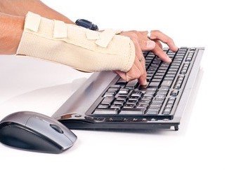 Person typing with wrist brace