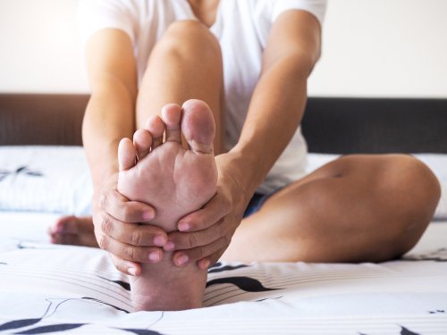 woman massaging foot