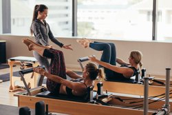 Girls doing exercises under the supervision of trainer