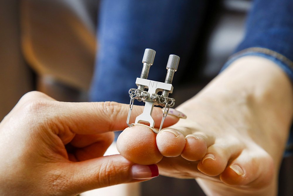 A podiatrist examining a patient