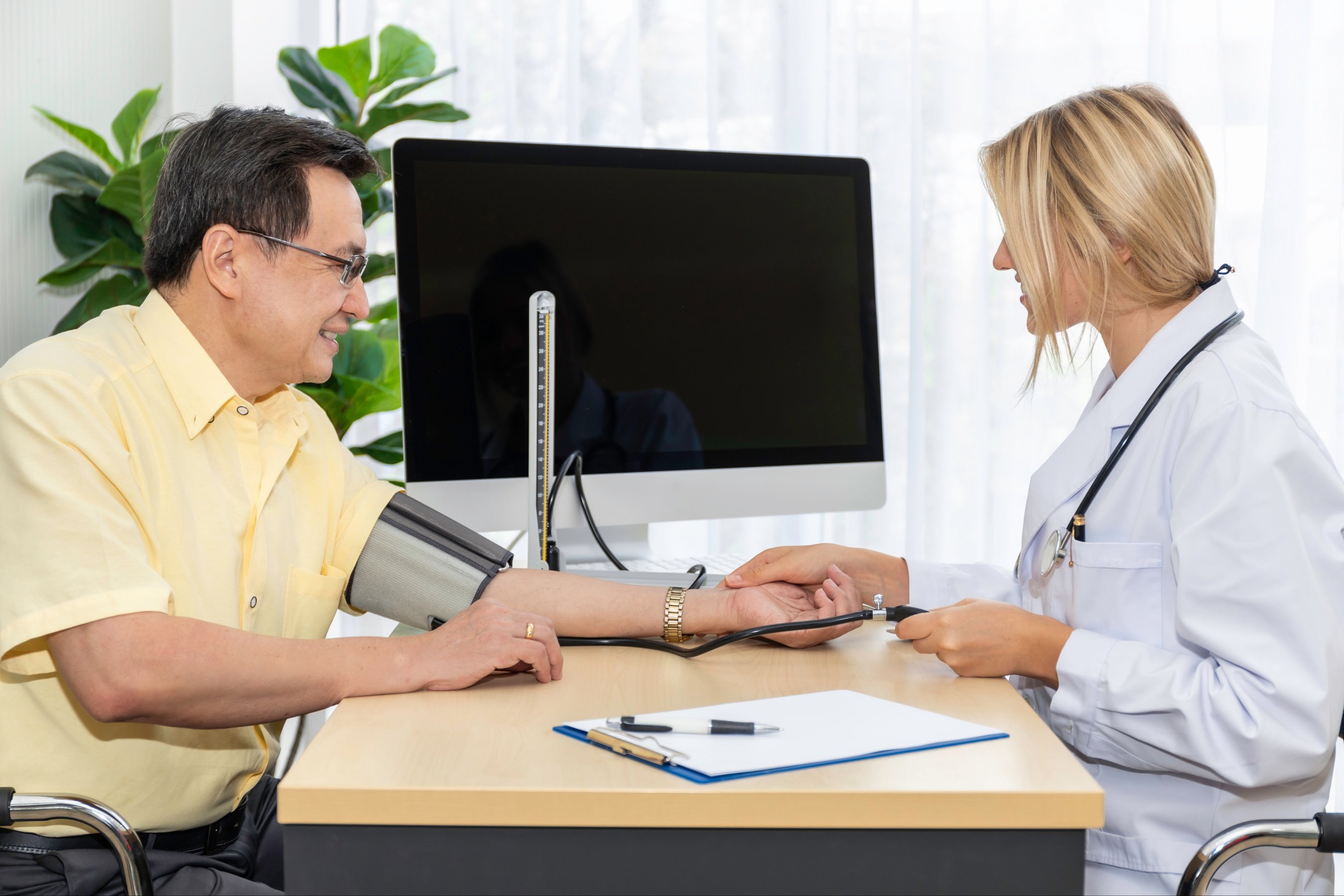 Woman Caucasian professional doctor check blood pressure with patient in the hospital room