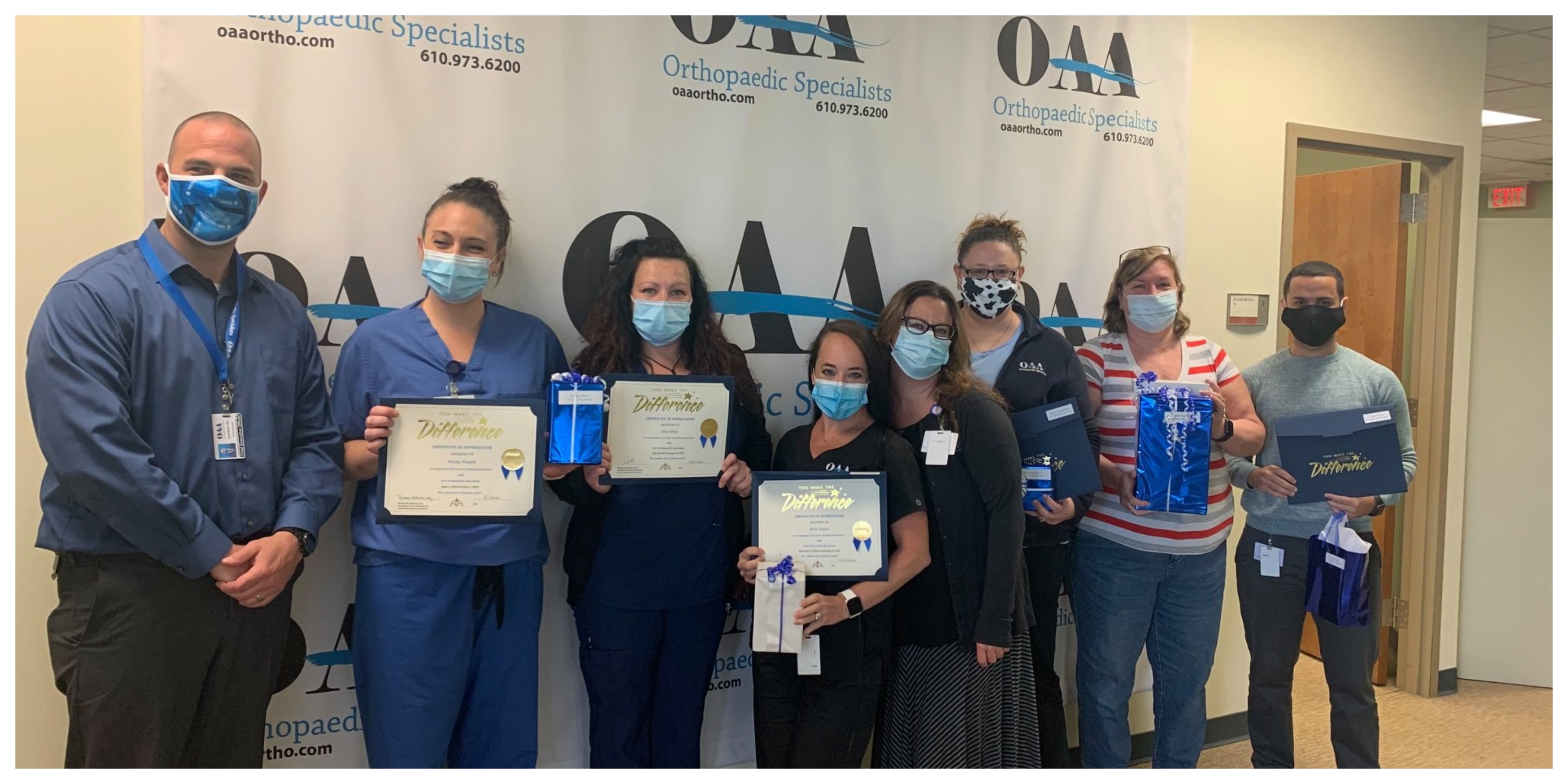 People in Masks Holding Difference Certificates