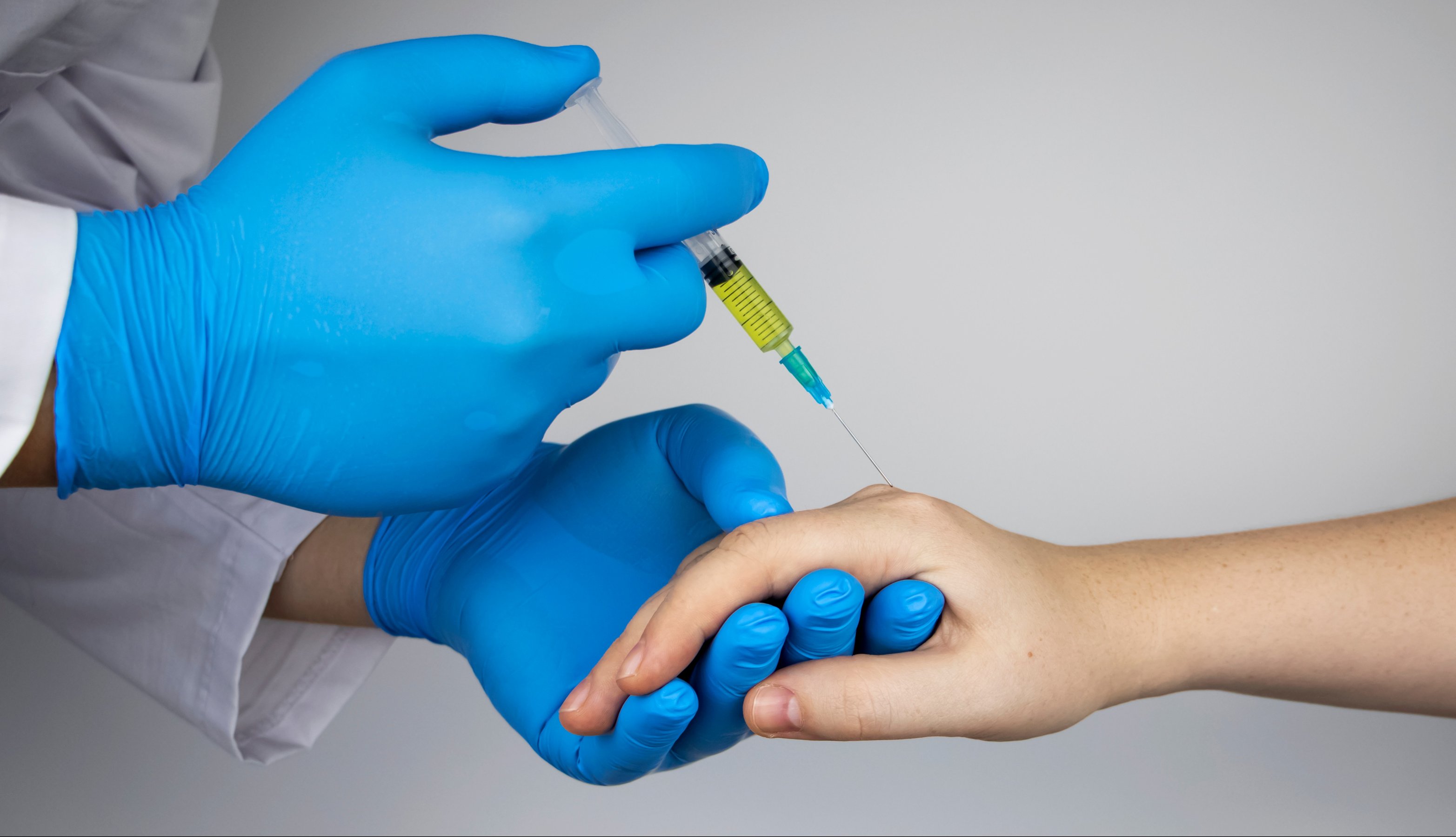 Orthopedic surgeon gives an injection in the finger joint