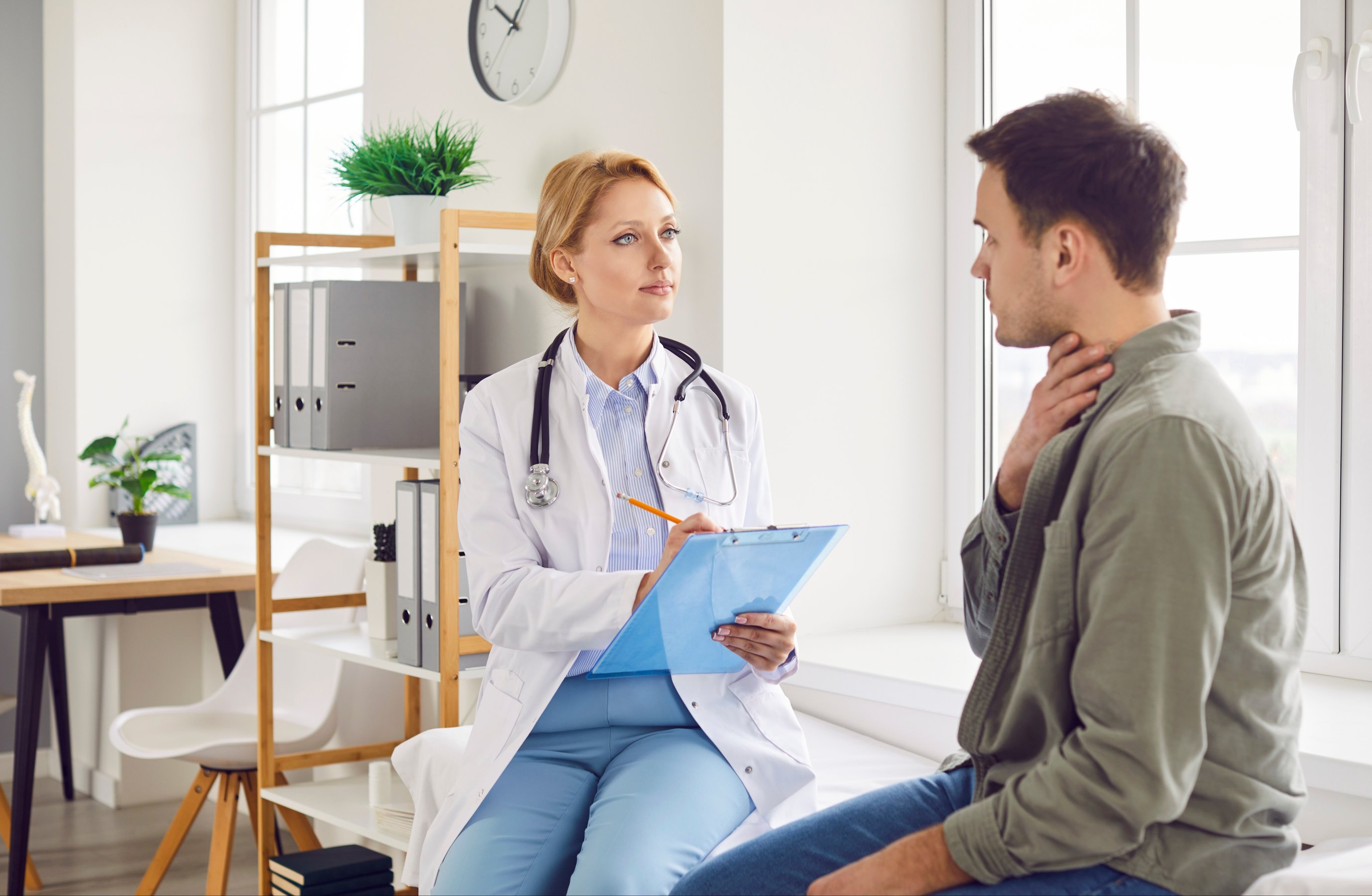 Female physician sitting with clipboard