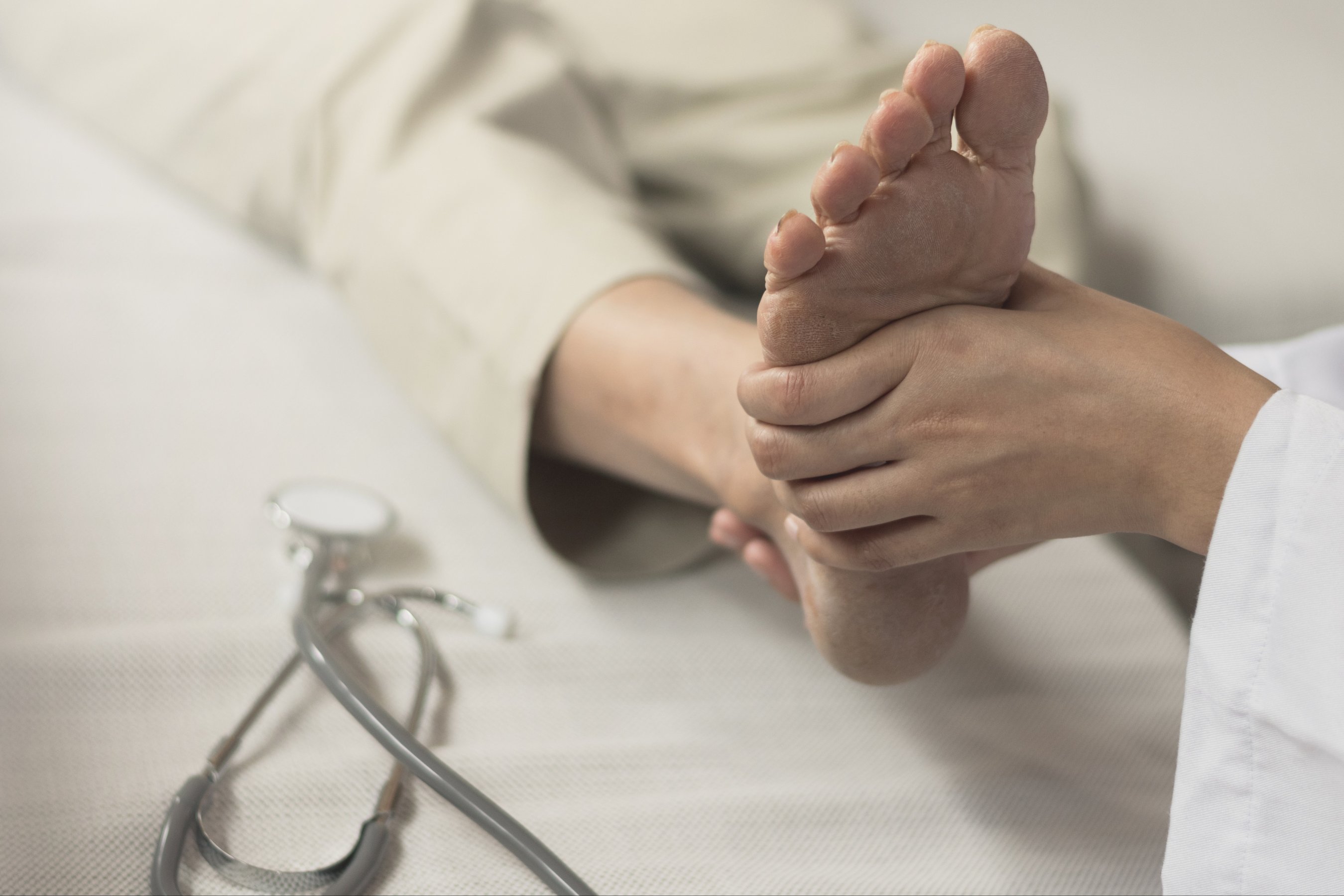 Doctor checking patient foot as suffer from inflammation feet problem