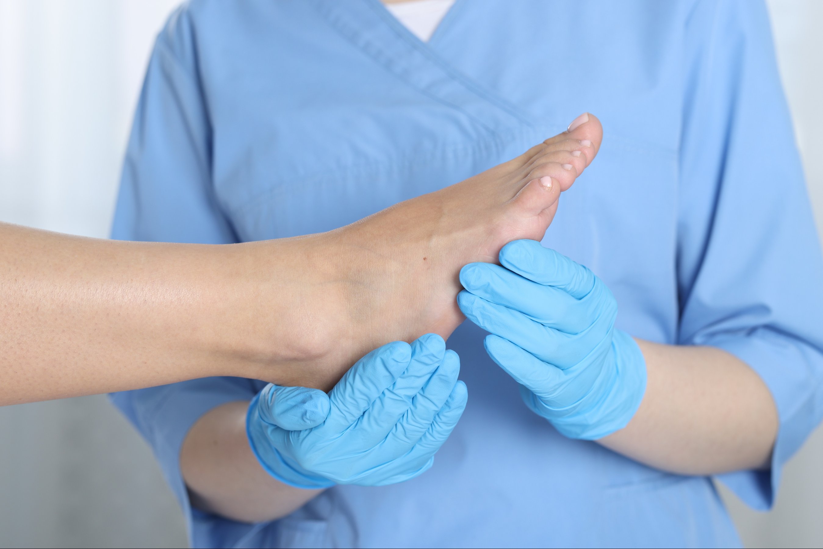 Doctor examining patient foot in hospital