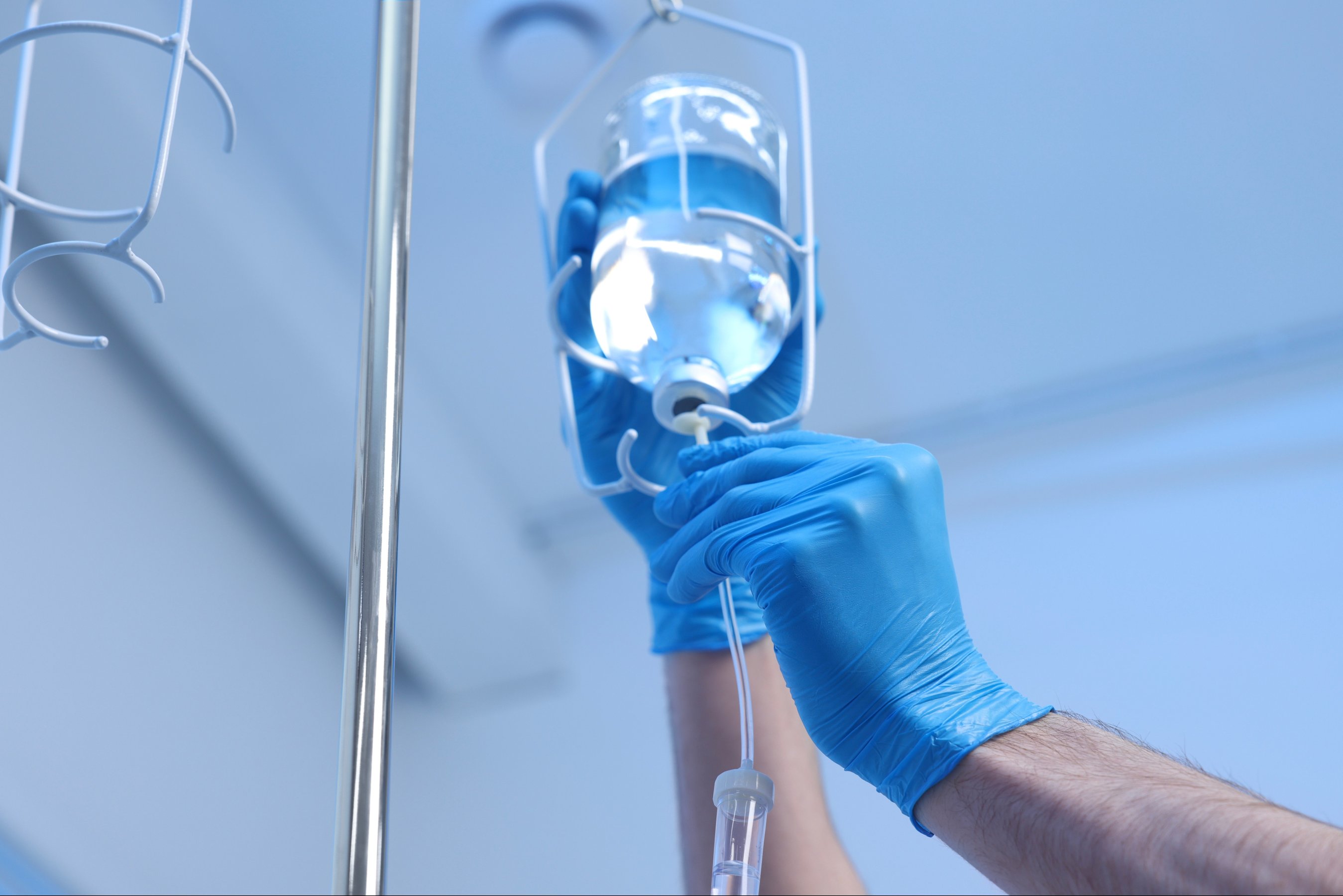Nurse setting up IV drip in hospital