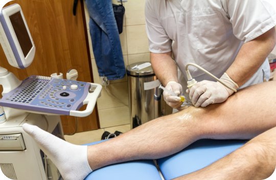 Doctor performing ultrasound on a patient's knee