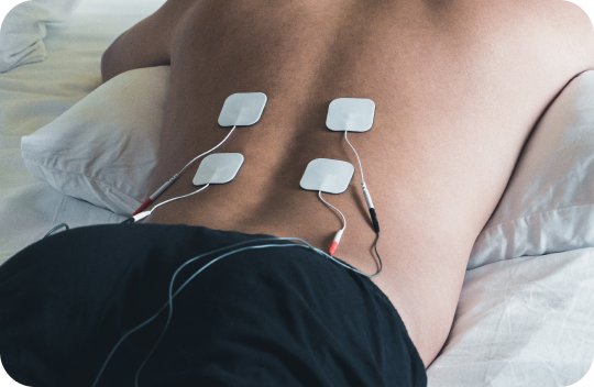 Patient with electro stimulation pads